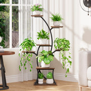 A 7-tier plant stand with grow lights, featuring a black metal frame and brown wooden shelves, with various plants and grow lights visible.