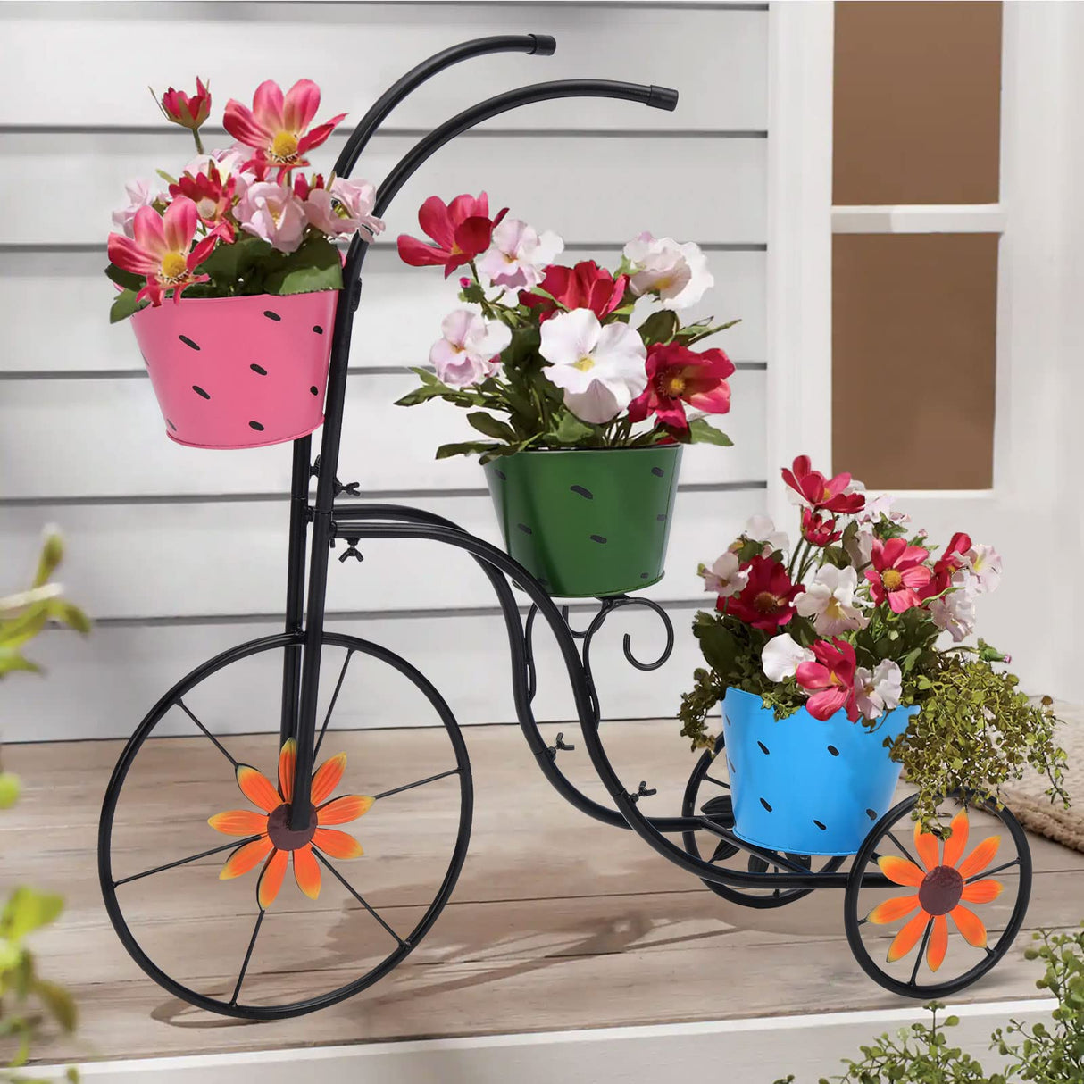 Black metal bicycle plant holder with colorful flower buckets