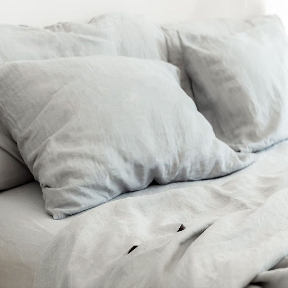 Luxurious Pure French Linen Sheets in Dove Grey, styled on a bed.