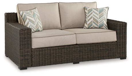Signature Design by Ashley Coastline Bay Casual Weather Resistant Outdoor Loveseat with Cushion and 2 Throw Pillows, Beige & Dark Brown