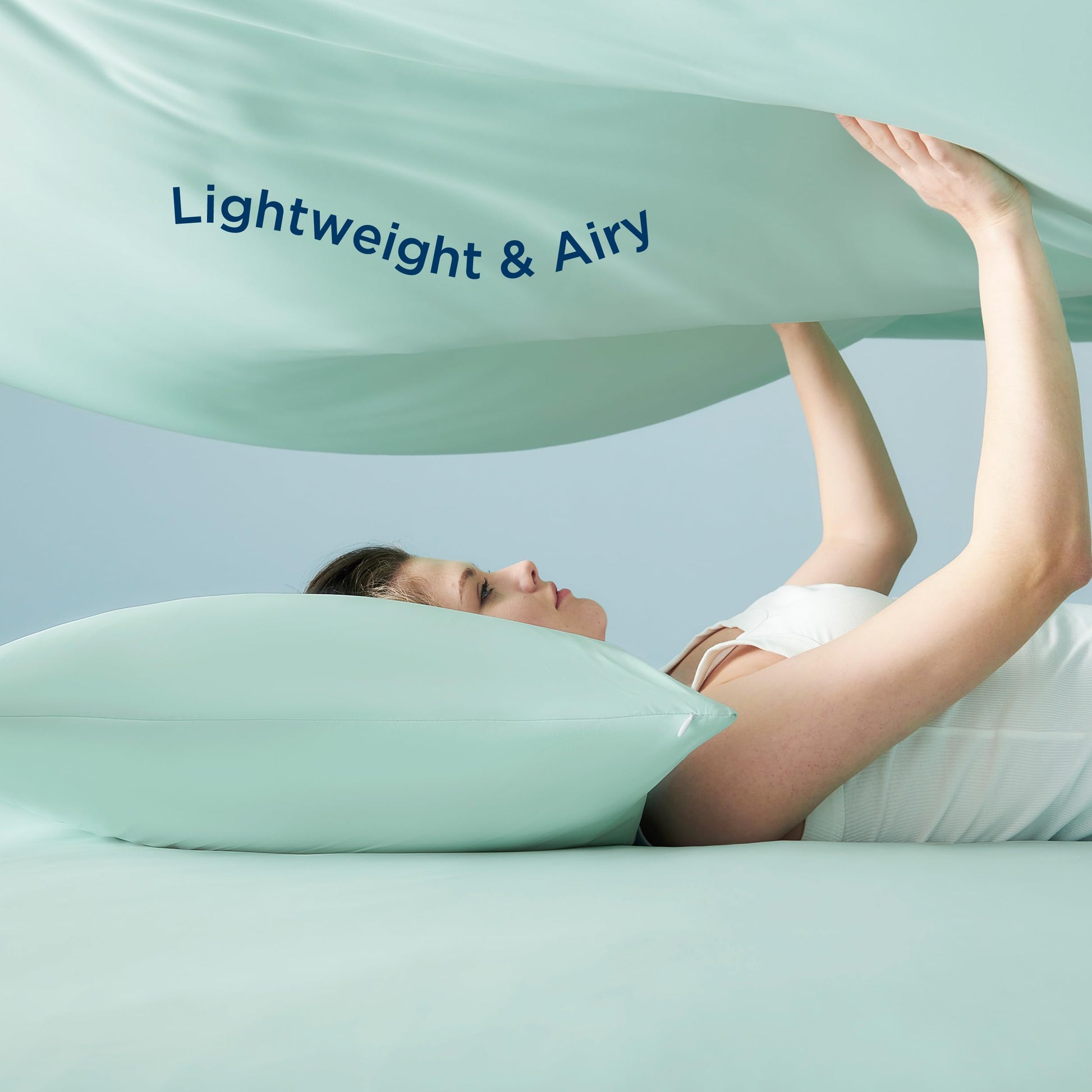 Hot sleeper resting under breathable cooling sheet