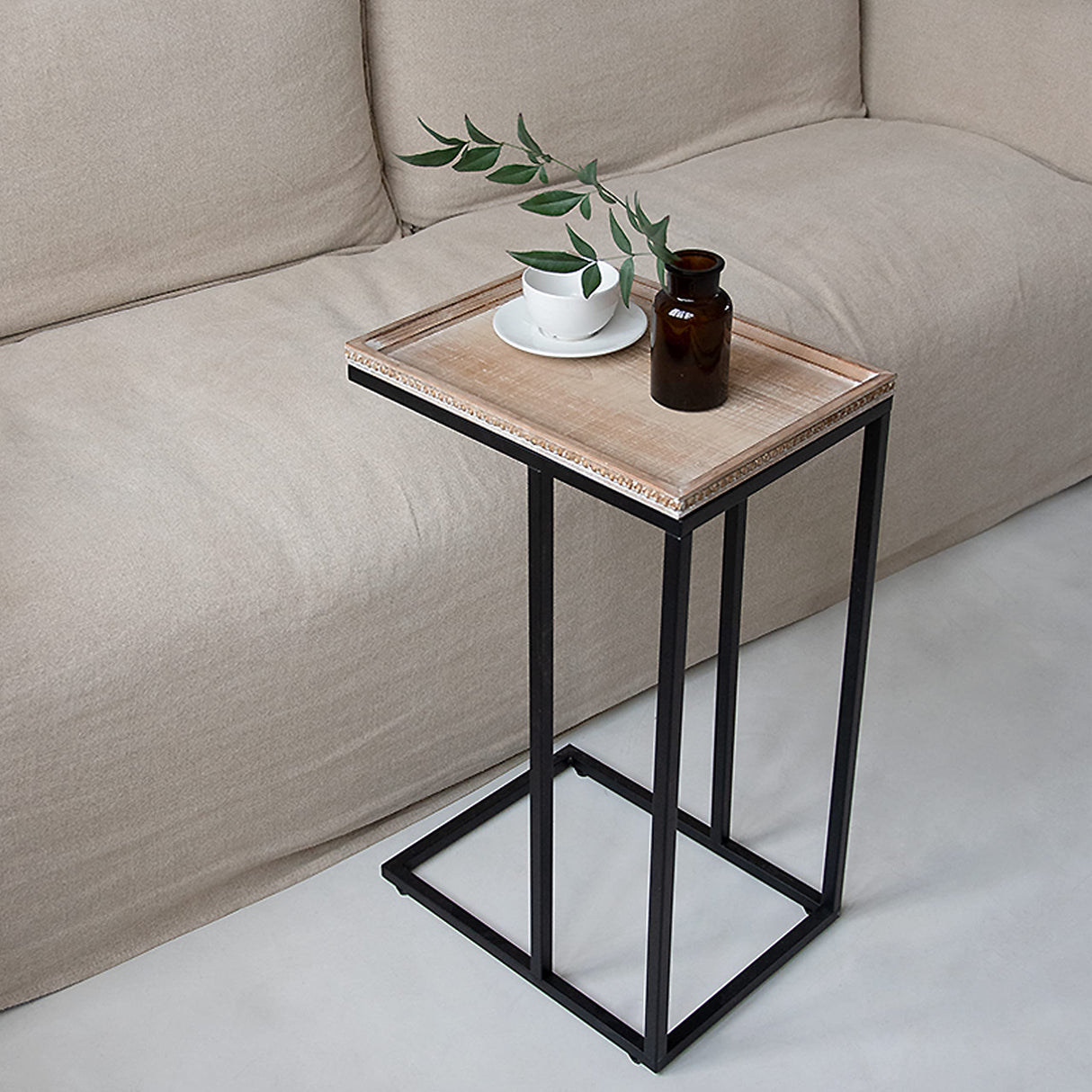 Minimalist C-table design in a modern living room setting