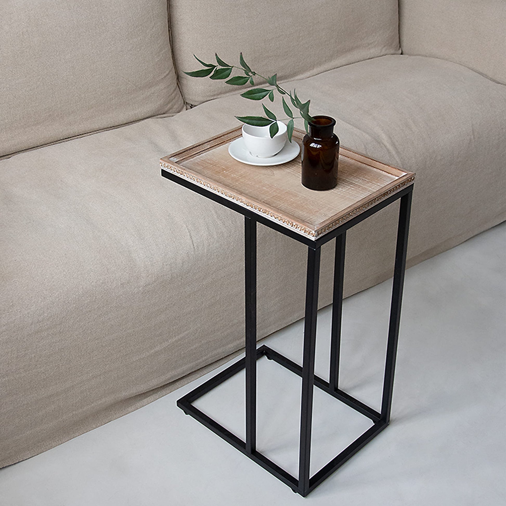 Minimalist C-table design in a modern living room setting
