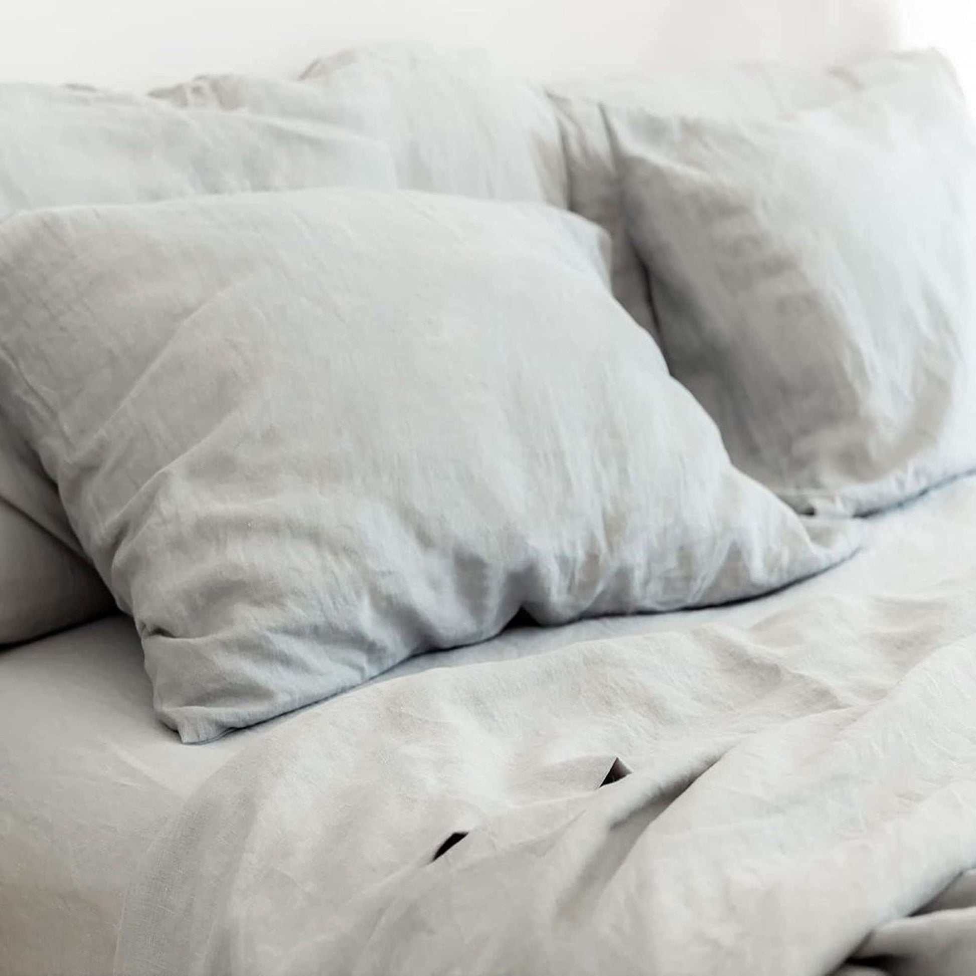  Luxurious Pure French Linen Sheets in Dove Grey, styled on a bed.