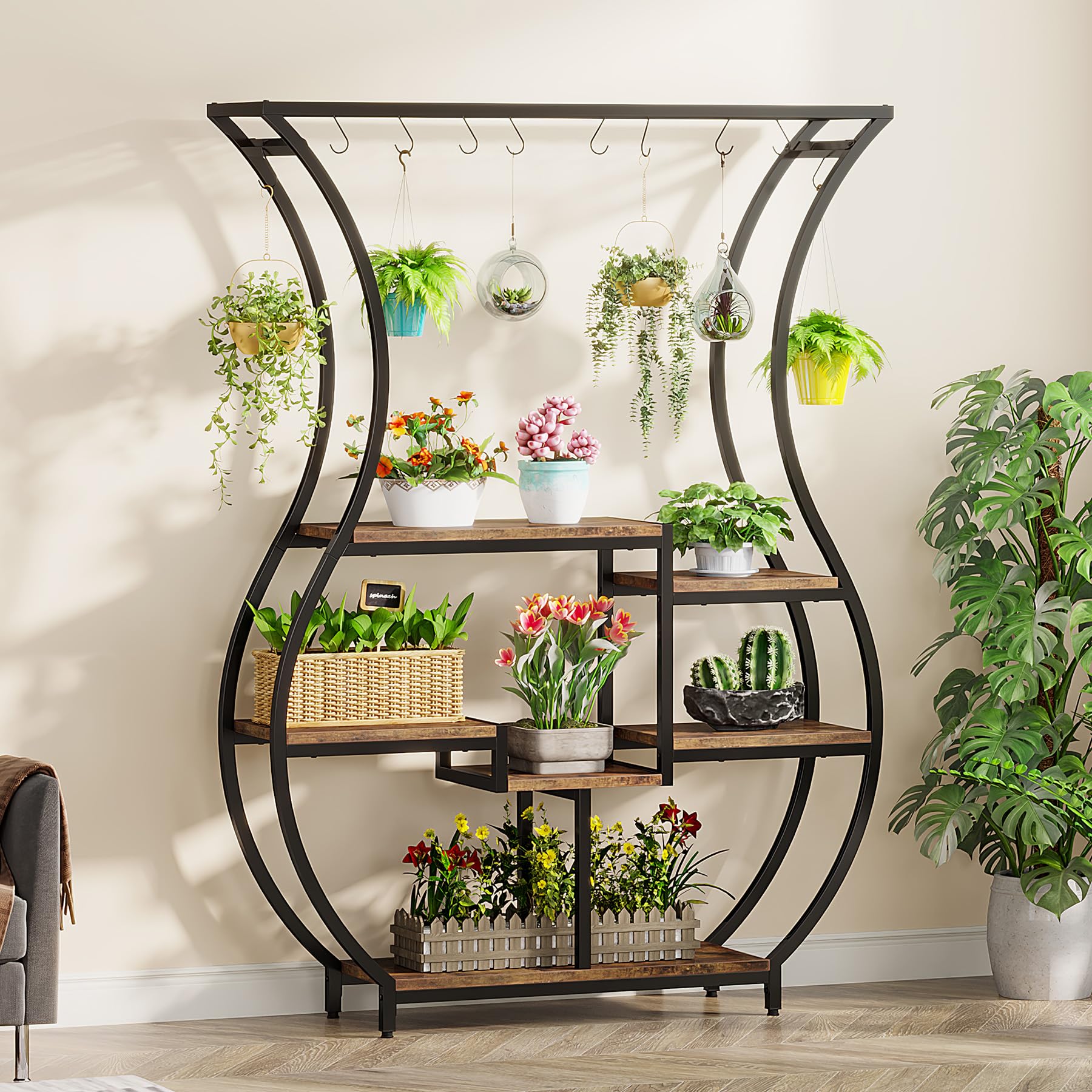 Tall metal plant stand with multiple shelves and hanging hooks