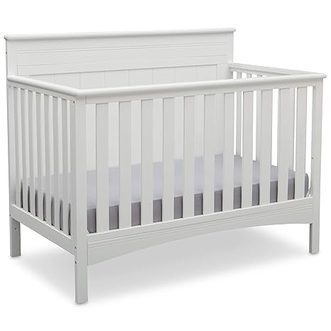 Convertible crib transitioning from baby bed to toddler bed