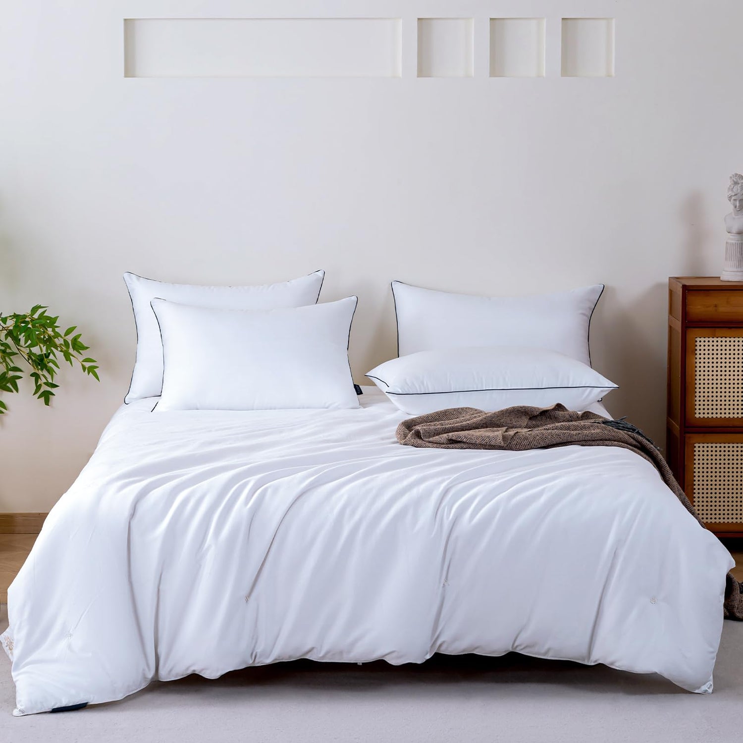Luxurious king-size bed with soft white pillows and a cozy comforter in a modern bedroom setting.