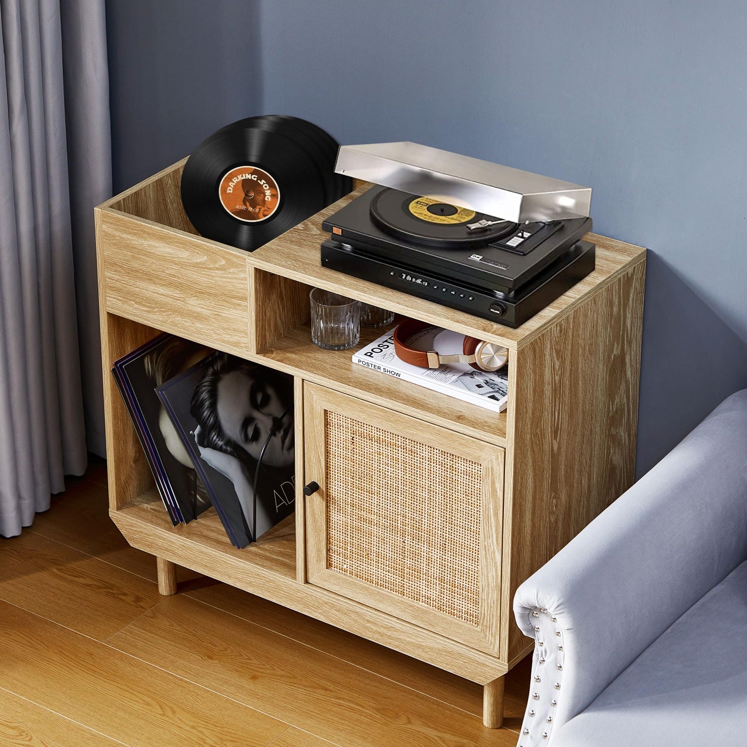 Rattan vinyl record player stand with solid wood legs, turntable storage, and album organizer in a modern living room.